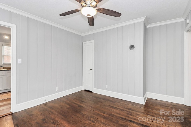 2421 Shamrock Dr, Charlotte, NC 28205 - empty room featuring crown molding, dark wood-type flooring, a ceiling fan, and baseboards
