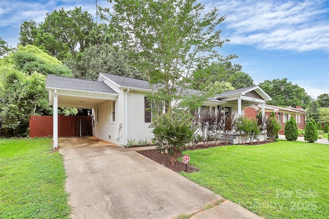 2421 Shamrock Dr, Charlotte, NC 28205 - ranch-style house with concrete driveway, a front yard, a carport, and a porch