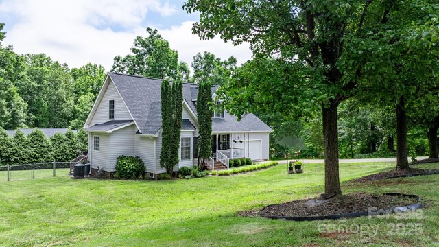 1321 Birch Dr, Morganton, NC 28655 - view of side of home featuring a shingled roof, a garage, and central AC