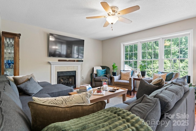 1321 Birch Dr, Morganton, NC 28655 - living room with a ceiling fan, a textured ceiling, and a tile fireplace