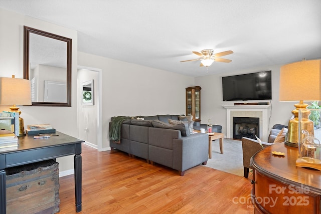 1321 Birch Dr, Morganton, NC 28655 - living room featuring light wood-style floors, a ceiling fan, and a fireplace