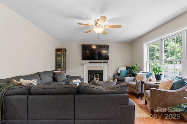 1321 Birch Dr, Morganton, NC 28655 - living area with ceiling fan, light wood finished floors, and a tile fireplace