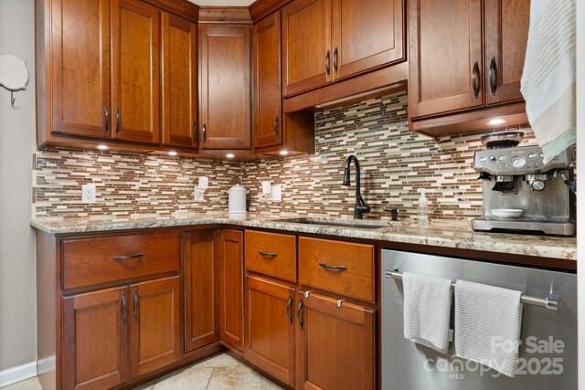 1321 Birch Dr, Morganton, NC 28655 - kitchen with a sink, stainless steel dishwasher, tasteful backsplash, brown cabinets, and light stone counters