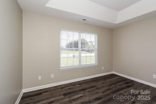 2599 April Showers Ln, Rock Hill, SC 29730 - unfurnished room with dark wood finished floors, baseboards, and a tray ceiling