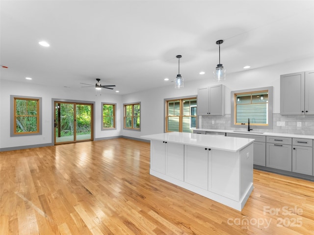 314 Gallimore Rd Unit 1, Brevard, NC 28712 - kitchen featuring gray cabinets, a center island, a sink, ceiling fan, and light countertops