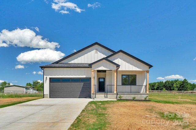 2104 County Line Rd, Kings Mountain, NC 28086 - modern farmhouse style home with an attached garage, board and batten siding, a porch, concrete driveway, and a shingled roof