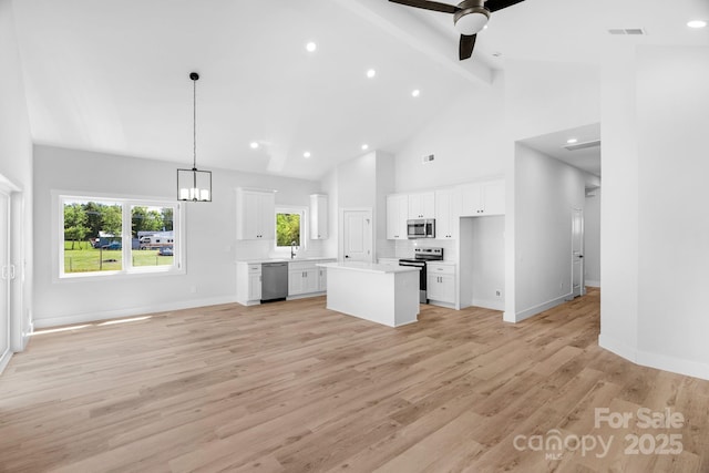 2104 County Line Rd, Kings Mountain, NC 28086 - unfurnished living room with beamed ceiling, a ceiling fan, high vaulted ceiling, light wood-type flooring, and a chandelier