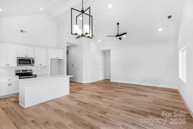 2104 County Line Rd, Kings Mountain, NC 28086 - kitchen featuring appliances with stainless steel finishes, high vaulted ceiling, baseboards, white cabinets, and a ceiling fan