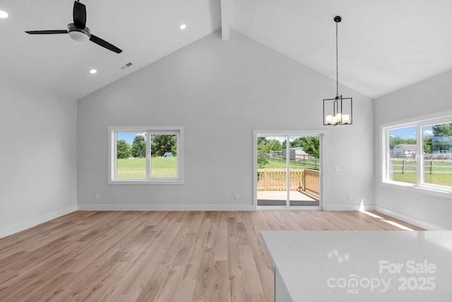 2104 County Line Rd, Kings Mountain, NC 28086 - unfurnished living room with high vaulted ceiling, light wood-type flooring, a ceiling fan, a chandelier, and beam ceiling