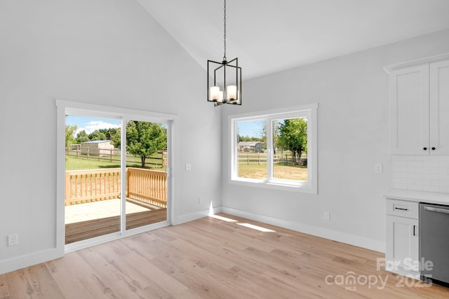 2104 County Line Rd, Kings Mountain, NC 28086 - unfurnished dining area with a chandelier, plenty of natural light, light wood-style flooring, and high vaulted ceiling