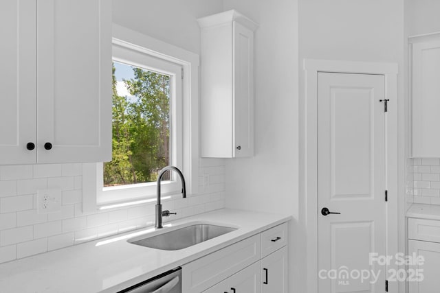 2104 County Line Rd, Kings Mountain, NC 28086 - kitchen featuring a sink, tasteful backsplash, and white cabinetry