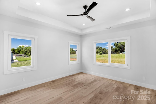 2104 County Line Rd, Kings Mountain, NC 28086 - unfurnished room featuring a tray ceiling, light wood-style flooring, baseboards, a ceiling fan, and recessed lighting