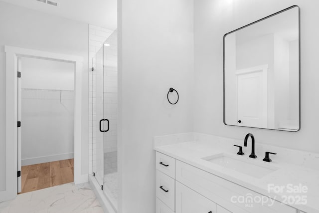 2104 County Line Rd, Kings Mountain, NC 28086 - full bathroom featuring vanity, a stall shower, a spacious closet, and marble finish flooring