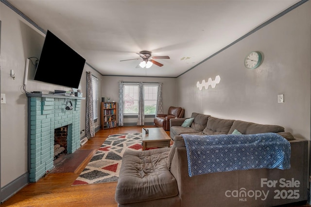 123 N Poston St, Shelby, NC 28150 - living area with ceiling fan, wood finished floors, baseboards, and a fireplace