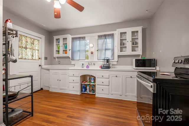 123 N Poston St, Shelby, NC 28150 - kitchen with stainless steel range with electric cooktop, ceiling fan, plenty of natural light, and white cabinets