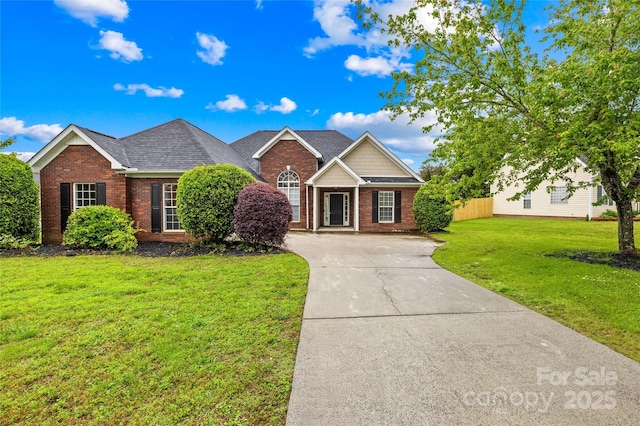4809 Mossy Cup Ln, Monroe, NC 28110 - traditional-style house featuring brick siding, a front yard, and driveway