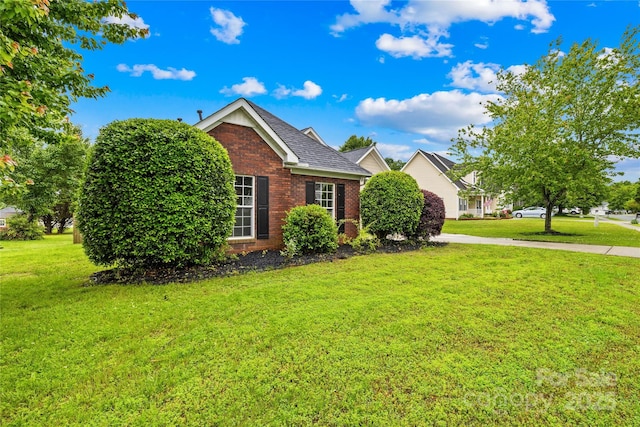 4809 Mossy Cup Ln, Monroe, NC 28110 - view of front of home featuring brick siding, a front yard, and roof with shingles