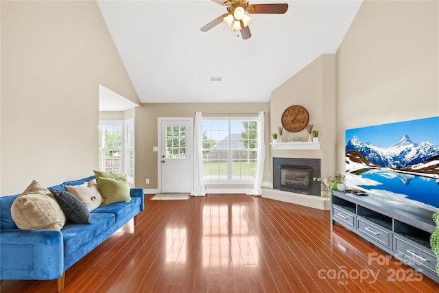 4809 Mossy Cup Ln, Monroe, NC 28110 - living area featuring a ceiling fan, a fireplace with raised hearth, lofted ceiling, wood finished floors, and baseboards