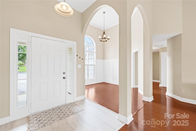 4809 Mossy Cup Ln, Monroe, NC 28110 - entrance foyer with plenty of natural light, a chandelier, a high ceiling, arched walkways, and wood finished floors
