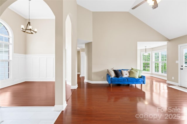 4809 Mossy Cup Ln, Monroe, NC 28110 - entrance foyer featuring wood finished floors, arched walkways, high vaulted ceiling, ceiling fan, and a chandelier