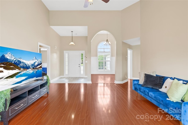 4809 Mossy Cup Ln, Monroe, NC 28110 - entryway featuring a towering ceiling, ceiling fan, baseboards, wood finished floors, and arched walkways