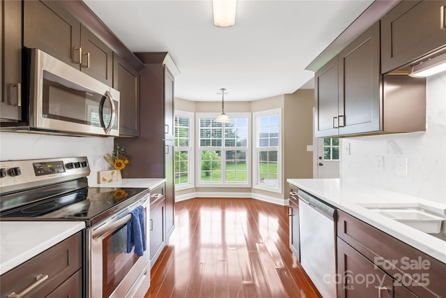 4809 Mossy Cup Ln, Monroe, NC 28110 - kitchen with appliances with stainless steel finishes, wood finished floors, light countertops, and baseboards