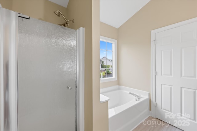 4809 Mossy Cup Ln, Monroe, NC 28110 - bathroom with a shower stall, a bath, lofted ceiling, and wood finished floors