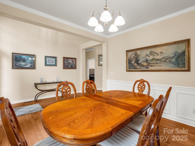 24 Yorktown Cir, Arden, NC 28704 - dining room featuring a chandelier, wood finished floors, crown molding, and a wainscoted wall