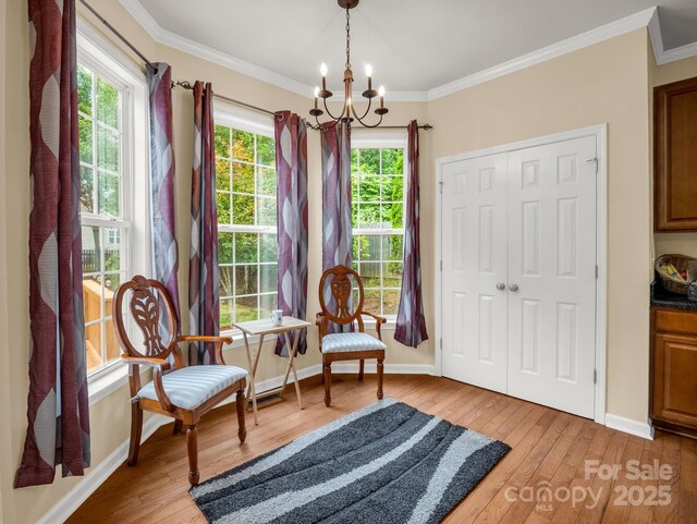 24 Yorktown Cir, Arden, NC 28704 - living area featuring a chandelier, light wood-style floors, baseboards, and ornamental molding