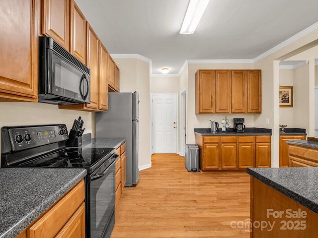 24 Yorktown Cir, Arden, NC 28704 - kitchen with black appliances, light wood finished floors, dark countertops, brown cabinetry, and crown molding