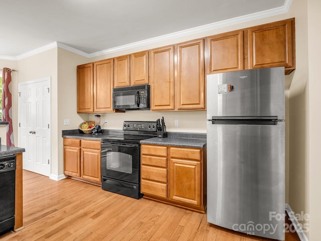 24 Yorktown Cir, Arden, NC 28704 - kitchen with black appliances, light wood finished floors, dark countertops, crown molding, and baseboards