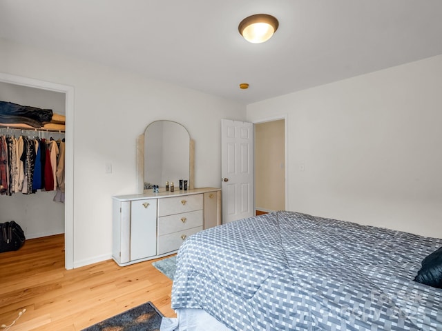 24 Yorktown Cir, Arden, NC 28704 - bedroom featuring light wood finished floors, a closet, a walk in closet, and baseboards