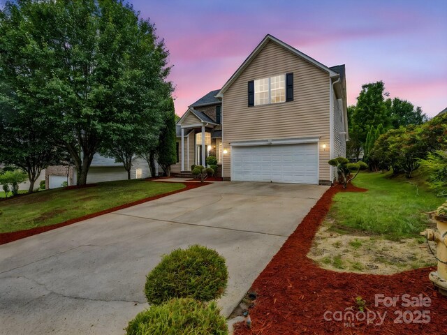 24 Yorktown Cir, Arden, NC 28704 - traditional-style home featuring an attached garage, concrete driveway, and a yard