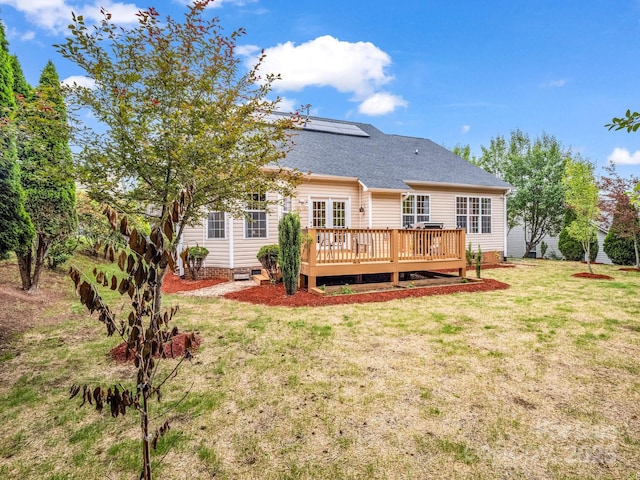 24 Yorktown Cir, Arden, NC 28704 - rear view of house with a deck, a yard, solar panels, and a shingled roof
