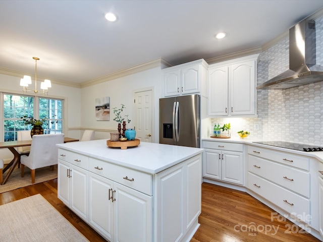 5816 Valley Stream Trl, Waxhaw, NC 28173 - kitchen featuring stainless steel fridge with ice dispenser, wall chimney exhaust hood, black electric stovetop, a chandelier, and ornamental molding