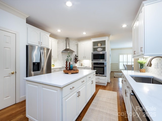 5816 Valley Stream Trl, Waxhaw, NC 28173 - kitchen with stainless steel appliances, wall chimney range hood, backsplash, a sink, and white cabinets