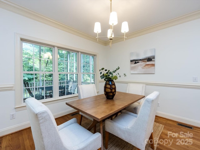 5816 Valley Stream Trl, Waxhaw, NC 28173 - dining room with ornamental molding, a chandelier, baseboards, and wood finished floors
