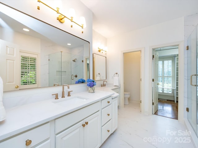 5816 Valley Stream Trl, Waxhaw, NC 28173 - full bathroom with double vanity, toilet, a marble finish shower, marble finish flooring, and recessed lighting