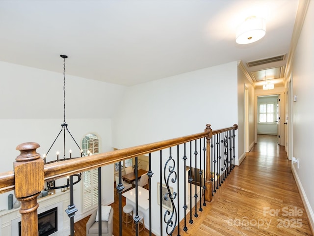 5816 Valley Stream Trl, Waxhaw, NC 28173 - hallway featuring attic access, light wood finished floors, a chandelier, and baseboards