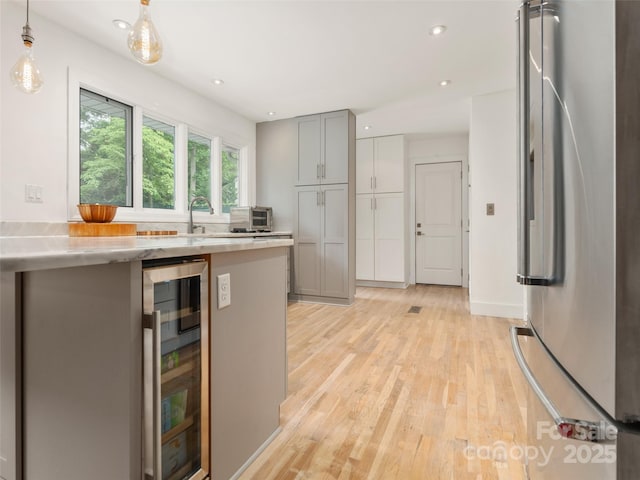 6 Browntown Rd, Asheville, NC 28803 - kitchen featuring wine cooler, freestanding refrigerator, light countertops, light wood-style floors, and recessed lighting