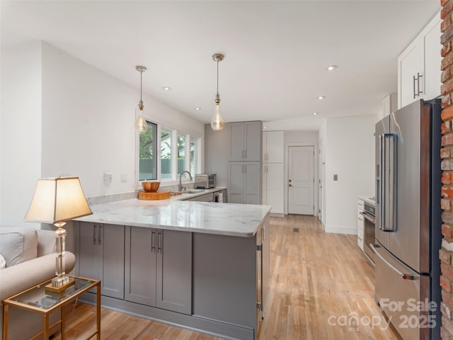 6 Browntown Rd, Asheville, NC 28803 - kitchen with high quality fridge, gray cabinets, a peninsula, light stone counters, and light wood-style flooring