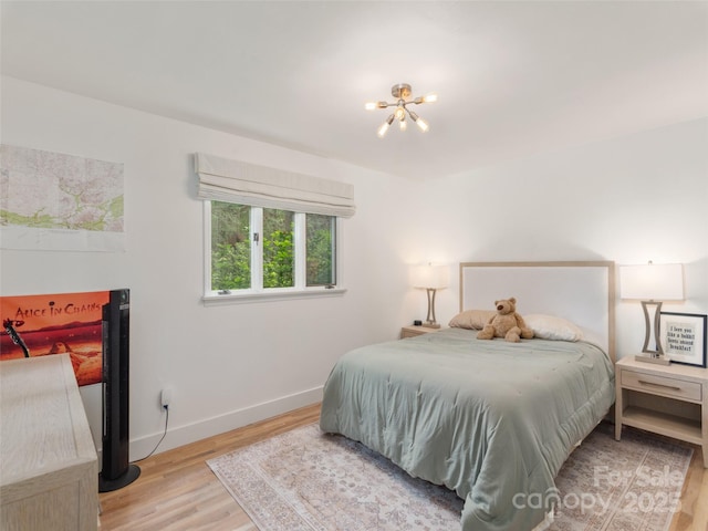 6 Browntown Rd, Asheville, NC 28803 - bedroom featuring a chandelier, wood finished floors, and baseboards