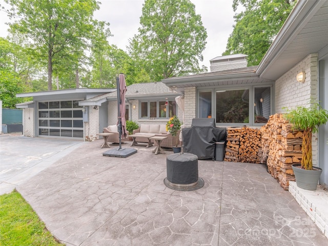 6 Browntown Rd, Asheville, NC 28803 - view of patio with concrete driveway, a grill, an outdoor living space, and an attached garage