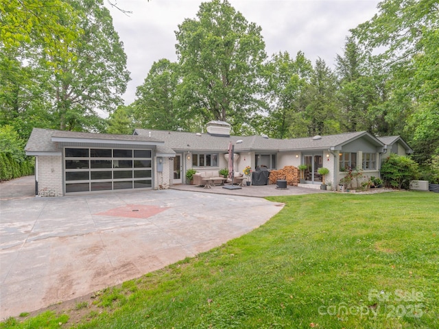 6 Browntown Rd, Asheville, NC 28803 - view of front facade with brick siding, driveway, a front yard, an attached garage, and a chimney