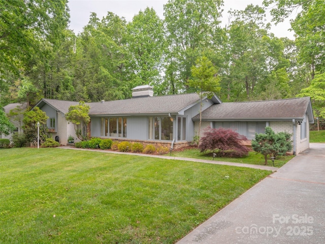 6 Browntown Rd, Asheville, NC 28803 - view of front of home with a front lawn, a chimney, and roof with shingles