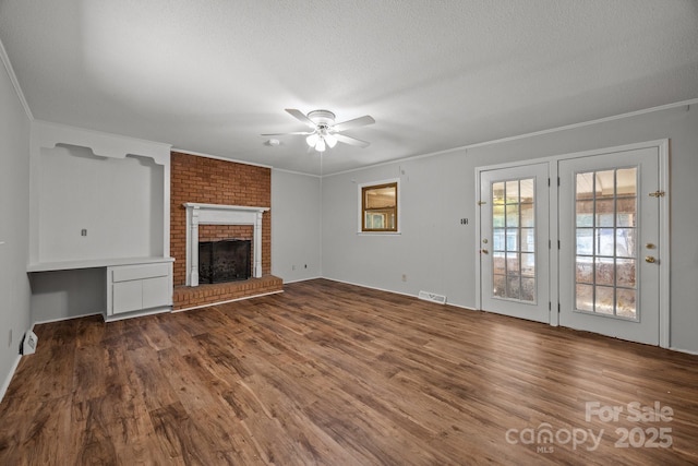 1810 Country Manor Ln Unit 34, Rock Hill, SC 29730 - unfurnished living room with crown molding, ceiling fan, wood finished floors, a fireplace, and a textured ceiling