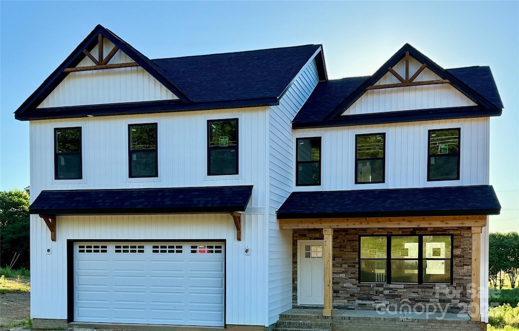 1308 Austin Chaney Rd, Wingate, NC 28174 - modern farmhouse featuring a shingled roof, a garage, and stone siding