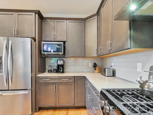 26 Addison Fisher Way, Asheville, NC 28805 - kitchen with appliances with stainless steel finishes, light stone countertops, tasteful backsplash, and range hood
