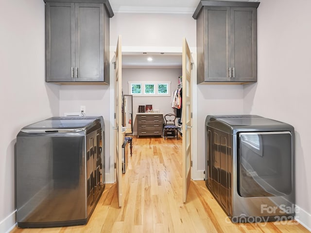 26 Addison Fisher Way, Asheville, NC 28805 - laundry area featuring independent washer and dryer, light wood-style floors, cabinet space, and ornamental molding