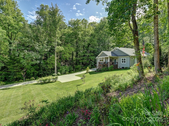 26 Addison Fisher Way, Asheville, NC 28805 - view of green lawn with a porch and a forest view